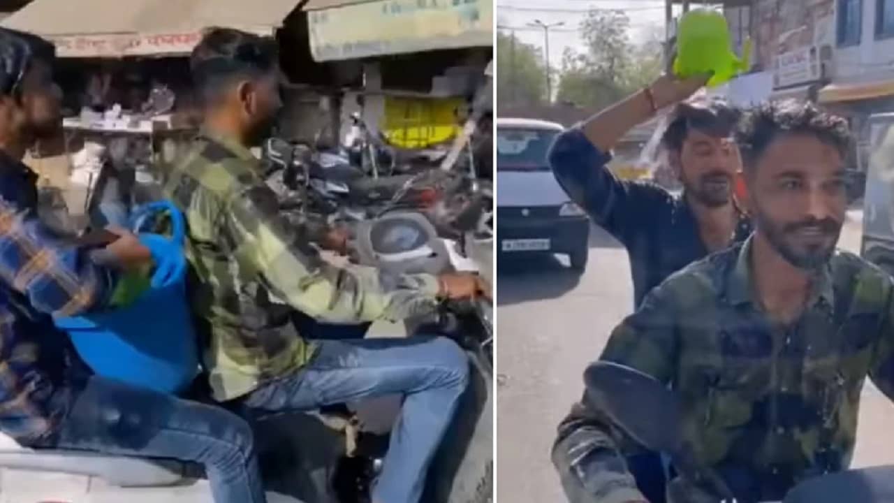 Viral Video: চাঁদিফাটা রোদ্দুরে মগ-বালতি নিয়ে ভ্রমণ! চলন্ত স্কুটারেই স্নান করে নিচ্ছেন এই দুই যুবক