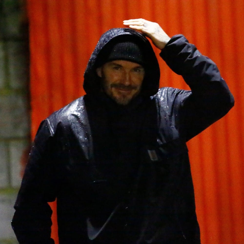 ছেলের অভিষেক ম্যাচ দেখতে ওয়েলিং স্টেডিয়ামে হাজির হয়েছিলেন ইংল্যান্ডের প্রাক্তন অধিনায়ক ডেভিড বেকহ্যাম। বৃষ্টিকে উপেক্ষা করেই কালো হুডি চাপিয়ে ছেলের খেলা দেখেন ডেভিড। (ছবি-টুইটার)