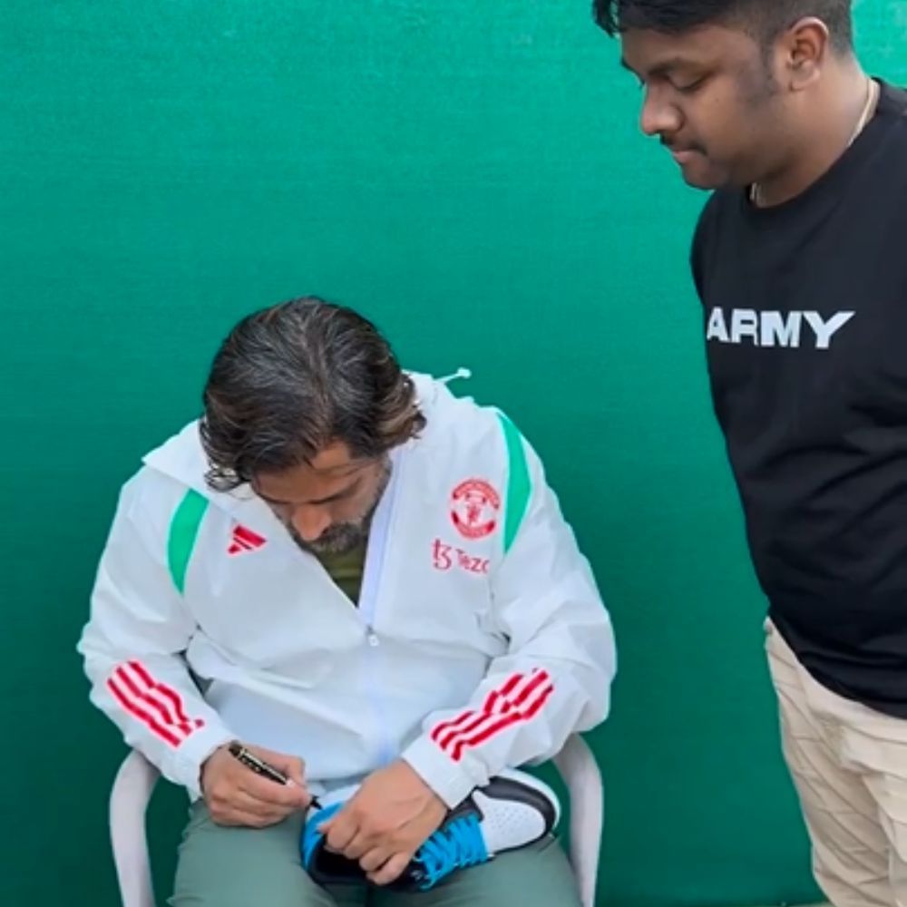 MSD give autograph to his fan in shoes